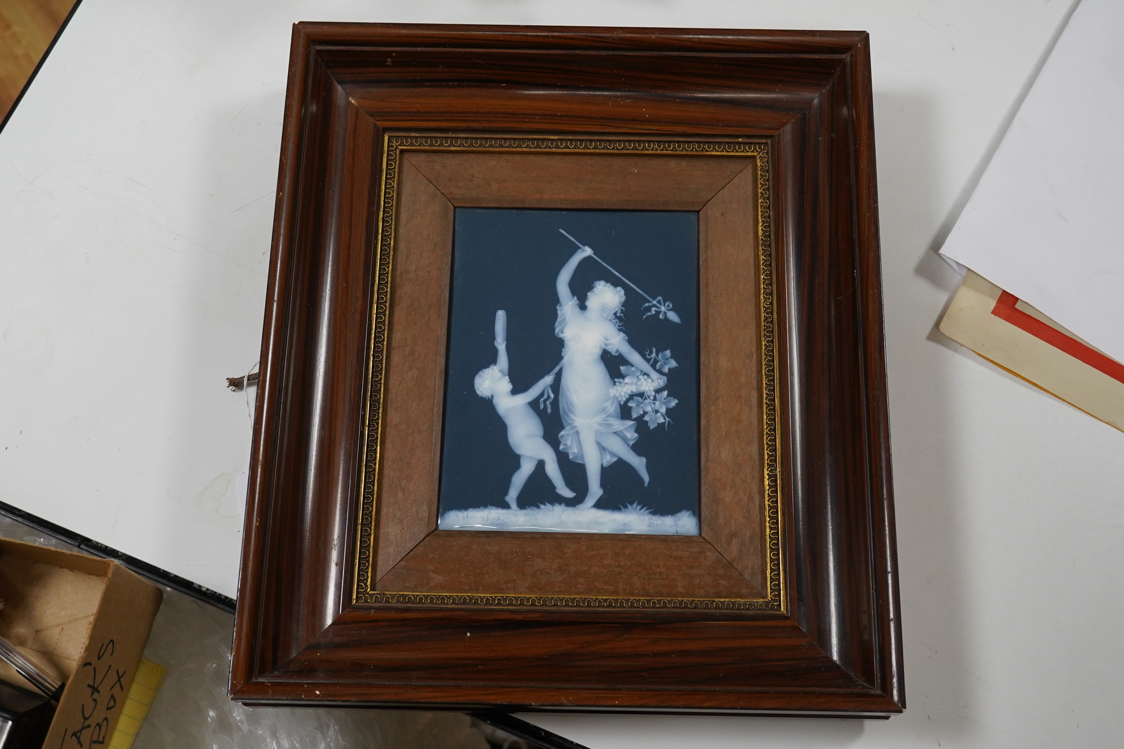 A Limoges pate-sur pate plaque of a musical putti and a dancing lady, signed. 17.5cm x 13cm. Condition - plaque good, frame slightly scratched